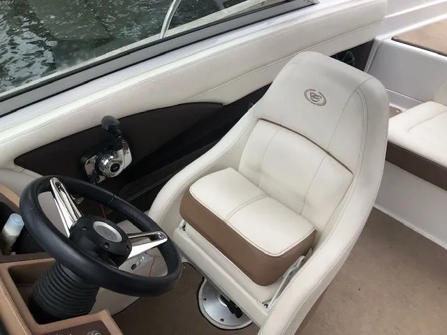 Slide: The Image of Interior of a 2014 Cobalt 210 boat with steering wheel and seat. - 4