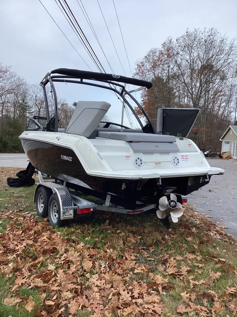 Slide: The Image of 2026 Cobalt CS22 boat on trailer amidst autumn leaves. - 3