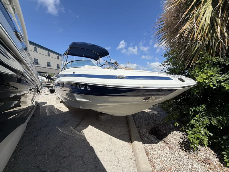 Slide: The Image of 2018 Crownline E24 XS boat outdoors in sunny weather. - 10