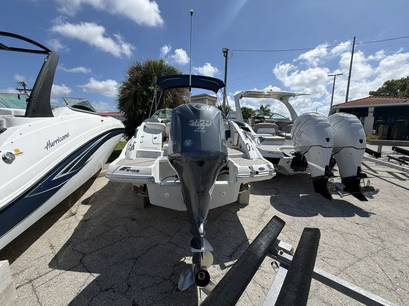 Slide: The Image of 2018 Crownline E24 XS boat with outboard motors on a parking lot. - 16