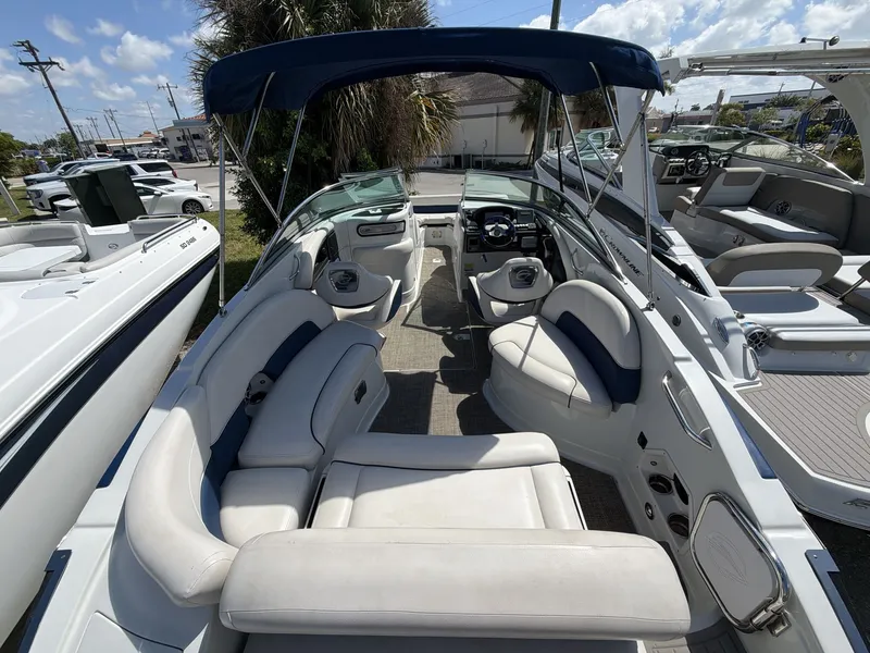 Slide: The Image of Interior view of a 2018 Crownline E24 XS boat with blue and white seating. - 18