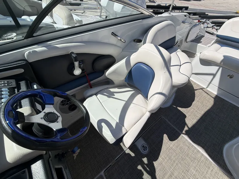 Slide: The Image of Interior of a 2018 Crownline E24 XS boat with steering wheel and seats. - 20