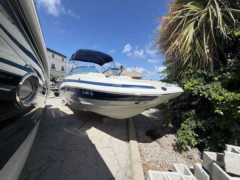 Slide: The Image of 2018 Crownline E24 XS boat parked outdoors. - 4