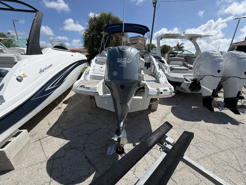 Slide: The Image of 2018 Crownline E24 XS boat with outboard motor, sunny day. - 7