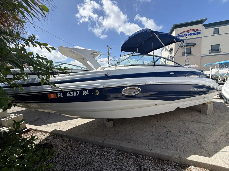 Slide: The Image of 2018 Crownline E24 XS boat in front of a building. - 9