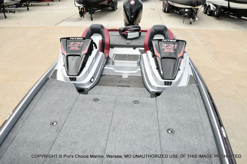 Slide: The Image of 2026 Nitro Z21 XL boat with gray deck and red seats. - 13
