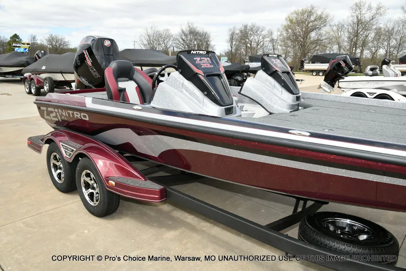 Slide: The Image of 2026 Nitro Z21 XL boat on trailer, red and silver, side view. - 4