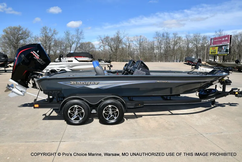 Slide: The Image of 2025 Ranger Alpha 208 Dual Console boat on trailer outdoors. - 19