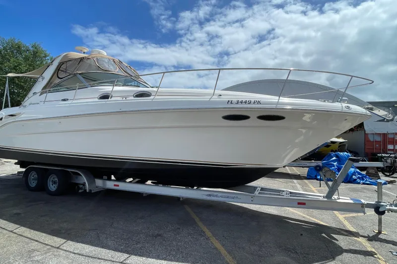 Slide: The Image of 2002 Sea Ray 340 Sundancer boat on trailer under blue sky. - 14