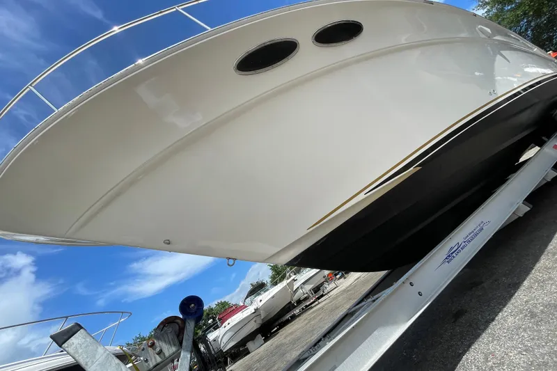 Slide: The Image of 2002 Sea Ray 340 Sundancer boat on trailer under clear blue sky. - 17