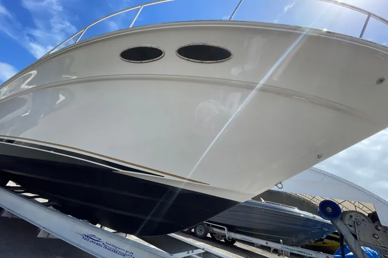 Slide: The Image of 2002 Sea Ray 340 Sundancer boat on trailer under blue sky. - 18