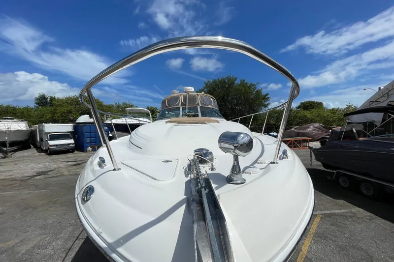 Slide: The Image of 2002 Sea Ray 340 Sundancer boat in a marina, under a clear blue sky. - 19