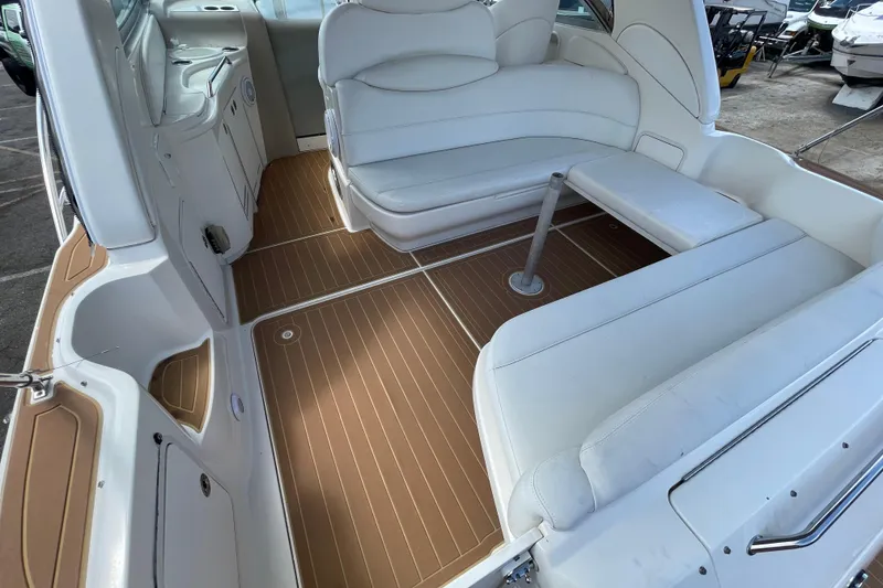 Slide: The Image of 2002 Sea Ray 340 Sundancer boat interior with white seating and brown flooring. - 21