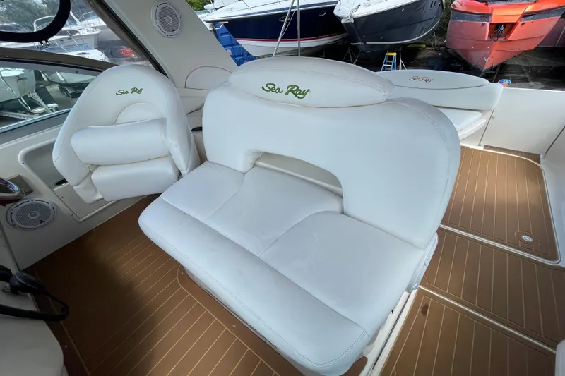 Slide: The Image of Interior of 2002 Sea Ray 340 Sundancer with white seating and wood-style flooring. - 24