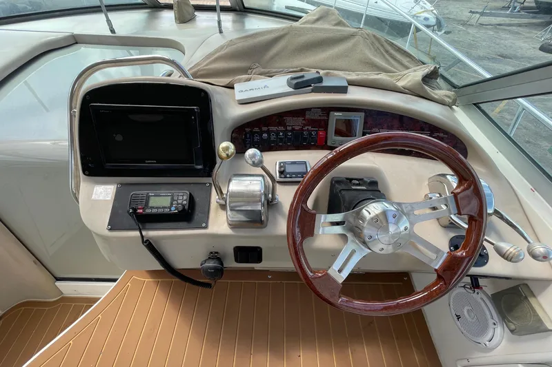 Slide: The Image of Cockpit of 2002 Sea Ray 340 Sundancer with wooden steering wheel. - 25