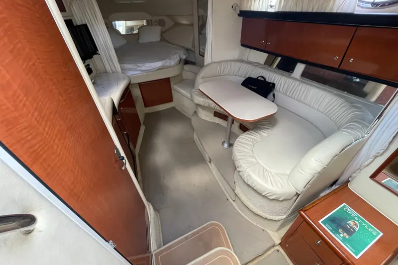 Slide: The Image of Interior of 2002 Sea Ray 340 Sundancer yacht with cozy seating and sleeping area. - 26