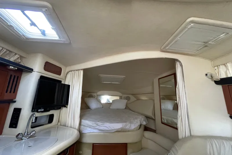 Slide: The Image of Interior of 2002 Sea Ray 340 Sundancer yacht with bed, TV, and sink. - 27