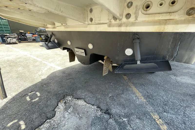 Slide: The Image of Rear view of a 2002 Sea Ray 340 Sundancer boat, showing trim tabs and hull details. - 31