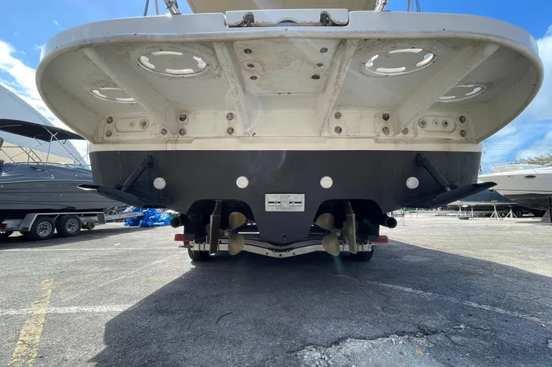Slide: The Image of Rear view of a 2002 Sea Ray 340 Sundancer boat on a trailer in a marina. - 32