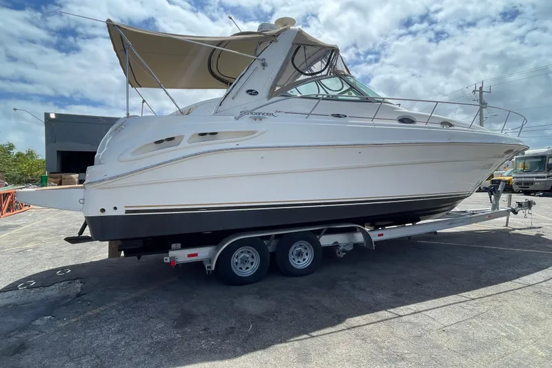 Slide: The Image of 2002 Sea Ray 340 Sundancer boat on trailer under cloudy sky. - 34