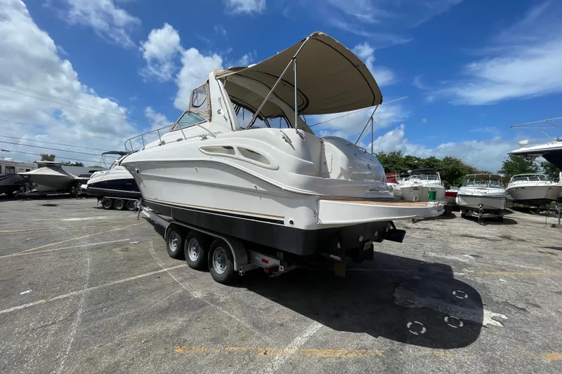 Slide: The Image of 2002 Sea Ray 340 Sundancer boat on trailer under clear blue sky. - 36