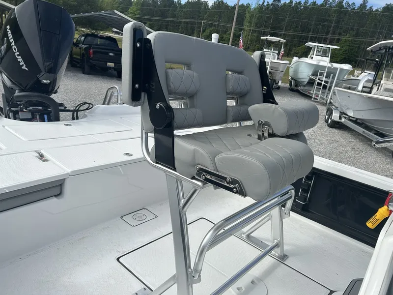 Slide: The Image of 2026 Blazer Purebay boat with gray seat and Mercury engine. - 4