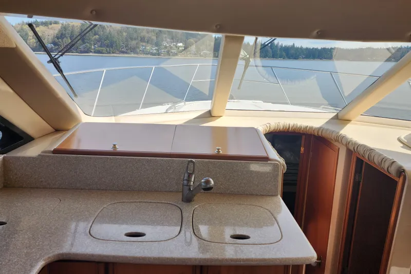 Slide: The Image of Interior view of 2003 Meridian 411 Sedan yacht with kitchen sink and scenic window view. - 12