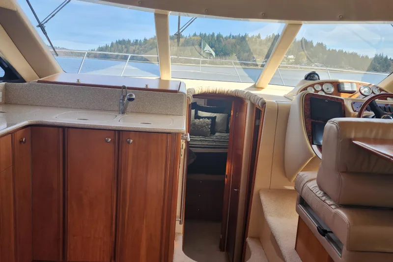 Slide: The Image of Interior of a 2003 Meridian 411 Sedan yacht with wood cabinetry and plush seating. - 13