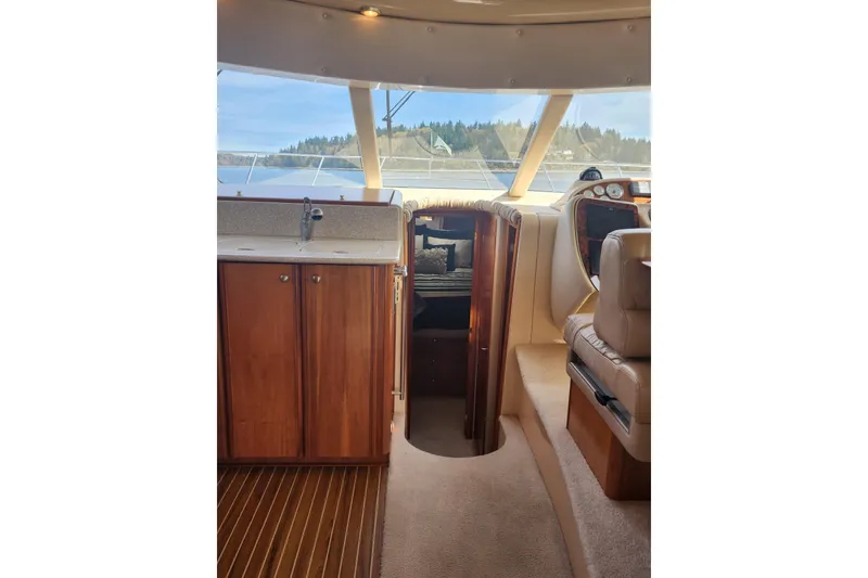 Slide: The Image of Interior of 2003 Meridian 411 Sedan yacht with wood cabinetry and plush seating. - 14