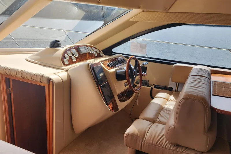 Slide: The Image of Interior of a 2003 Meridian 411 Sedan yacht, featuring a luxurious helm and seating area. - 16