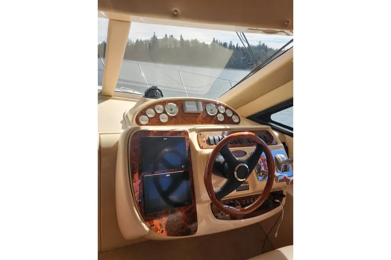 Slide: The Image of Helm of 2003 Meridian 411 Sedan yacht with wood accents and navigation instruments. - 18