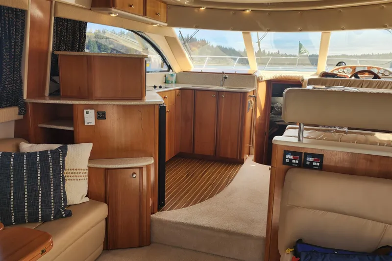 Slide: The Image of Interior of a 2003 Meridian 411 Sedan yacht with wooden cabinetry and plush seating. - 2