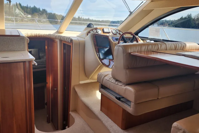 Slide: The Image of Interior of a 2003 Meridian 411 Sedan yacht with leather seating and wooden cabinetry. - 20