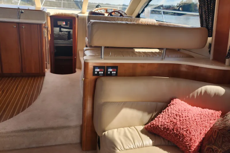 Slide: The Image of Interior of 2003 Meridian 411 Sedan yacht with plush seating and wooden cabinetry. - 21