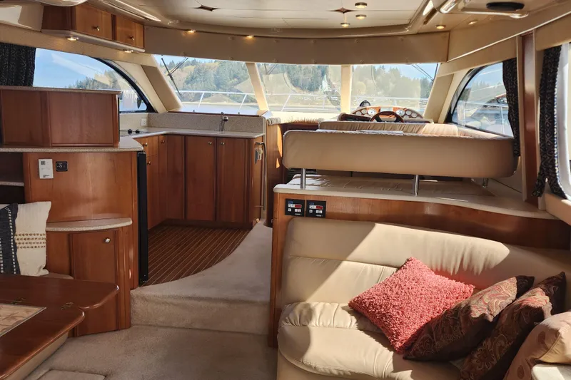 Slide: The Image of Luxurious interior of a 2003 Meridian 411 Sedan yacht with plush seating and wooden cabinetry. - 22