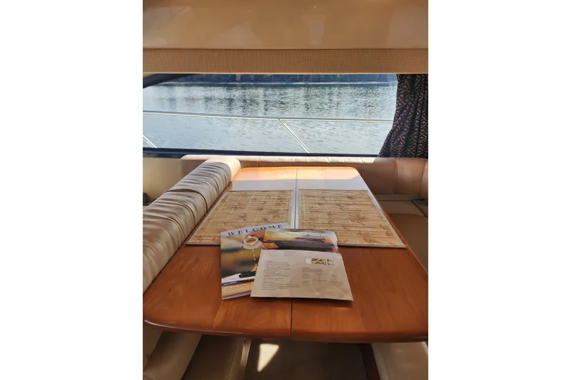 Slide: The Image of Interior of 2003 Meridian 411 Sedan yacht with table, brochures, and water view. - 23