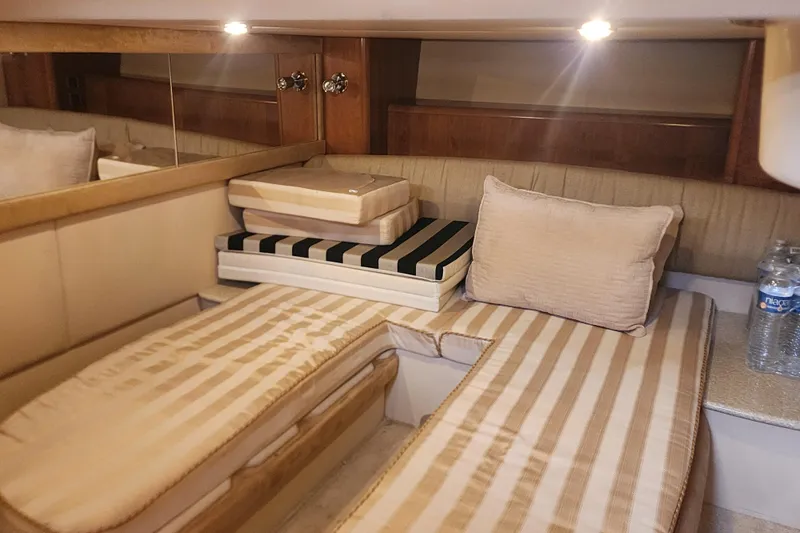 Slide: The Image of Interior cabin of 2003 Meridian 411 Sedan with striped cushions and pillows. - 24