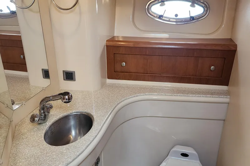 Slide: The Image of Luxurious bathroom in 2003 Meridian 411 Sedan yacht with sink, mirror, and wooden cabinet. - 27