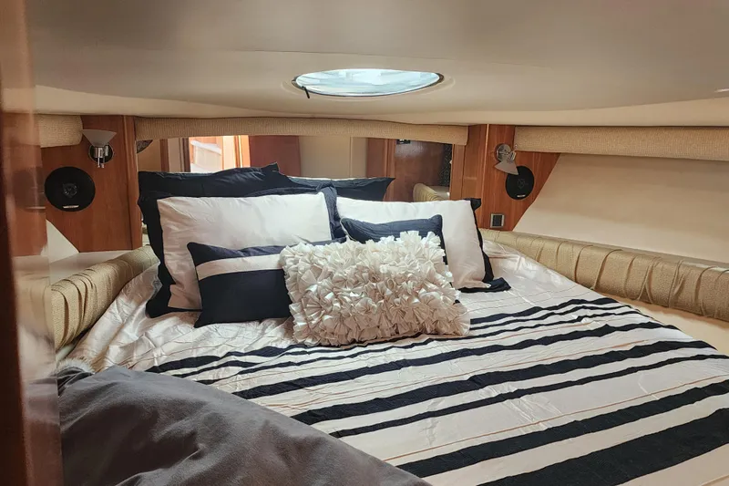 Slide: The Image of Luxurious bedroom interior of 2003 Meridian 411 Sedan yacht with striped bedding. - 29