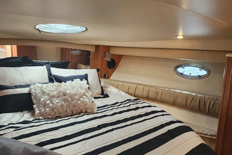 Slide: The Image of Luxurious cabin interior of 2003 Meridian 411 Sedan with striped bedding and decorative pillows. - 30