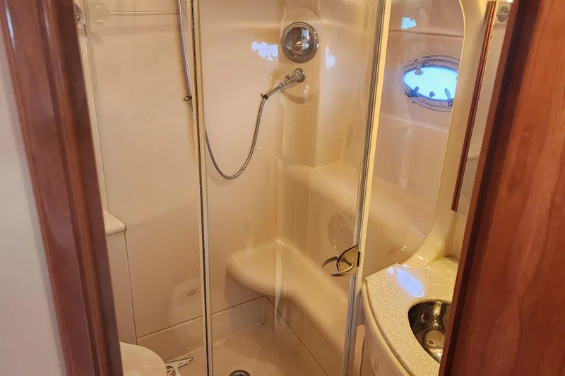 Slide: The Image of Luxurious bathroom in 2003 Meridian 411 Sedan yacht with shower and porthole window. - 31