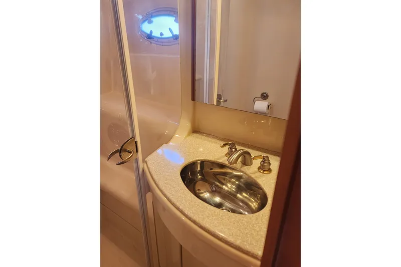 Slide: The Image of Bathroom interior of 2003 Meridian 411 Sedan yacht, featuring a sink and porthole window. - 32