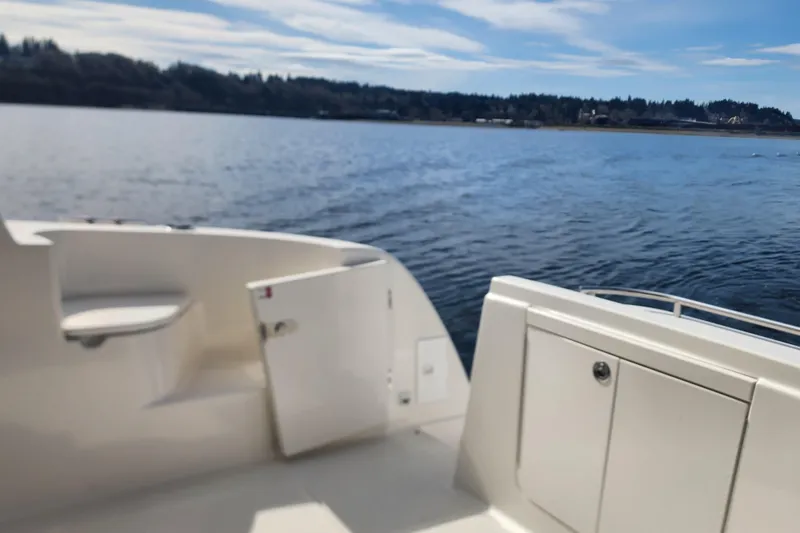 Slide: The Image of 2003 Meridian 411 Sedan boat deck overlooking serene lake and distant shoreline. - 36