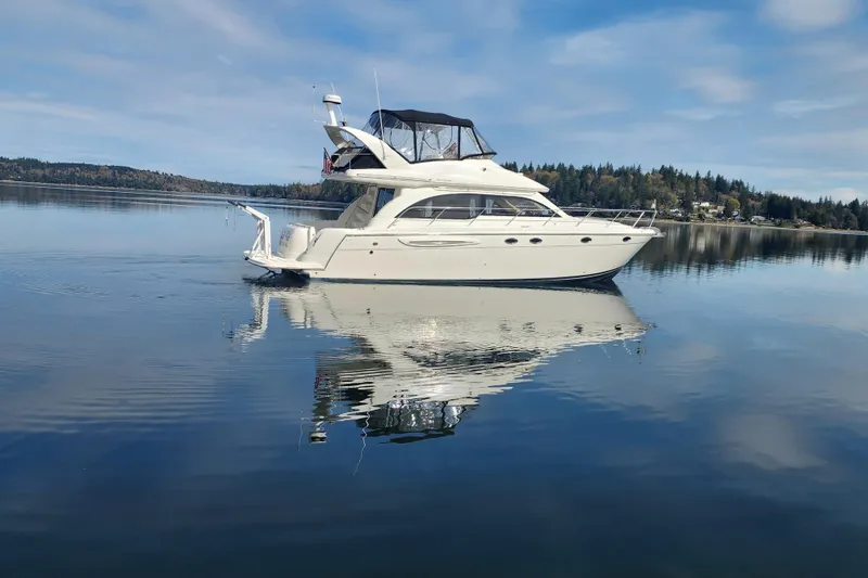 Slide: The Image of 2003 Meridian 411 Sedan yacht on calm water with scenic background. - 42