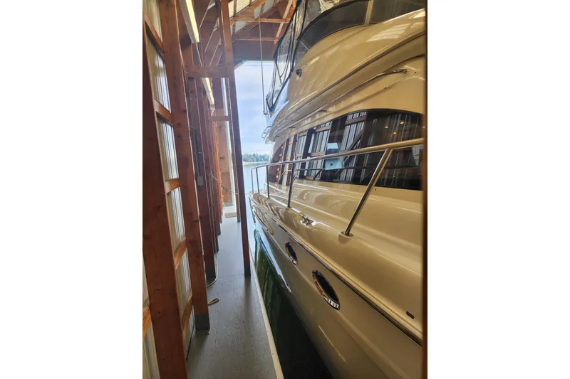 Slide: The Image of 2003 Meridian 411 Sedan yacht docked in a wooden boathouse. - 47