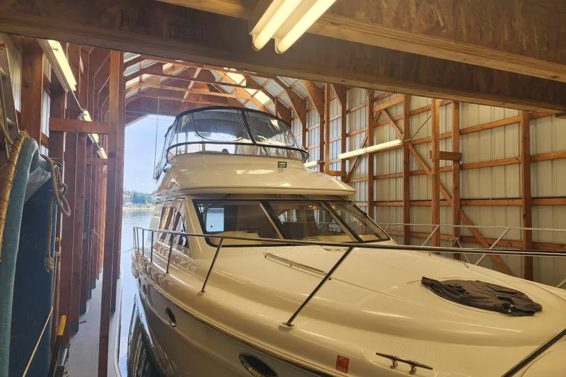 Slide: The Image of 2003 Meridian 411 Sedan yacht docked in a wooden boathouse. - 48