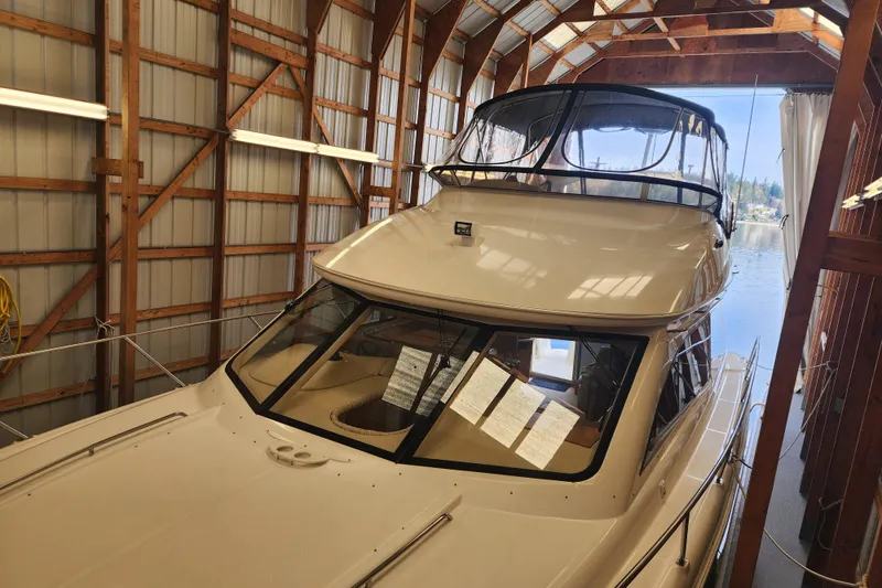 Slide: The Image of 2003 Meridian 411 Sedan yacht docked in a wooden boathouse. - 49