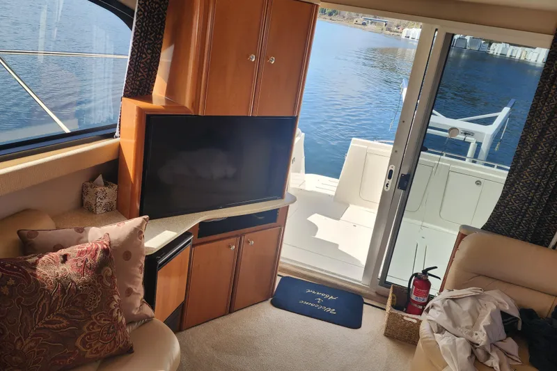 Slide: The Image of Interior of 2003 Meridian 411 Sedan yacht with TV, cushions, and lake view. - 5