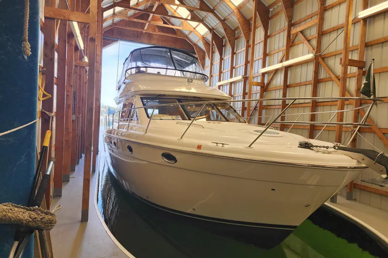 Slide: The Image of 2003 Meridian 411 Sedan yacht docked in a wooden boathouse. - 52