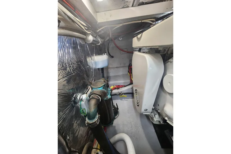 Slide: The Image of Engine room of a 2003 Meridian 411 Sedan, showcasing mechanical components and wiring. - 56